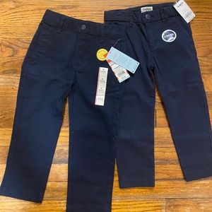 New with Tags, 2 navy pants, boys size 4. Brands: OshKosh and Cat & Jack